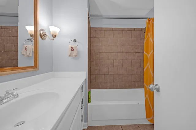 a bathroom with a bathtub and shower