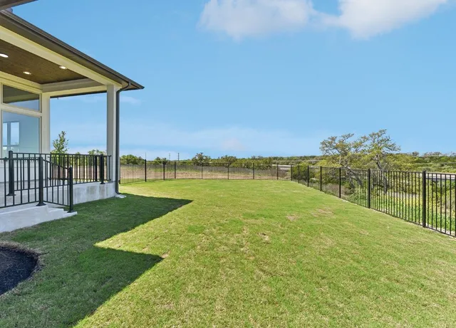 a view of a house with a yard and a lake view