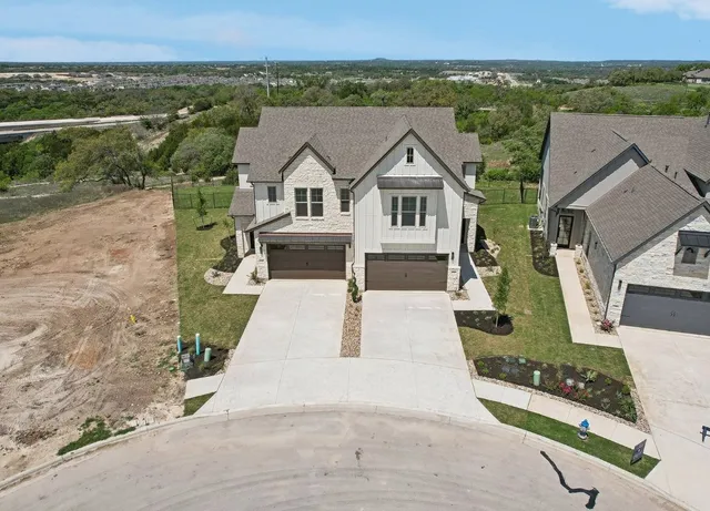 an aerial view of a house with a yard