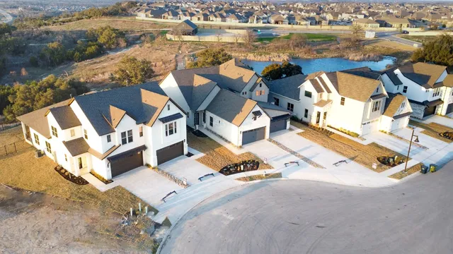 an aerial view of a house with outdoor space and lake view