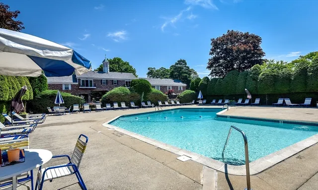 a view of a swimming pool and lounge chairs