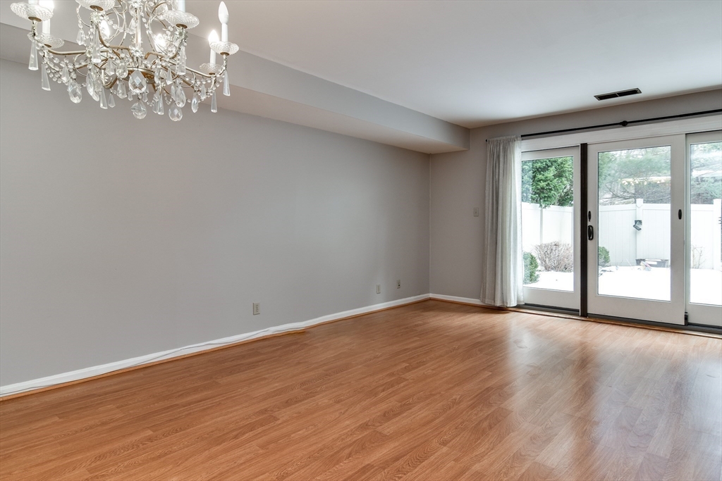 1907 Windsor Drive, Unit 1907 Framingham, MA 01701 - Photo 5 of 22 a view of an empty room with wooden floor and a window