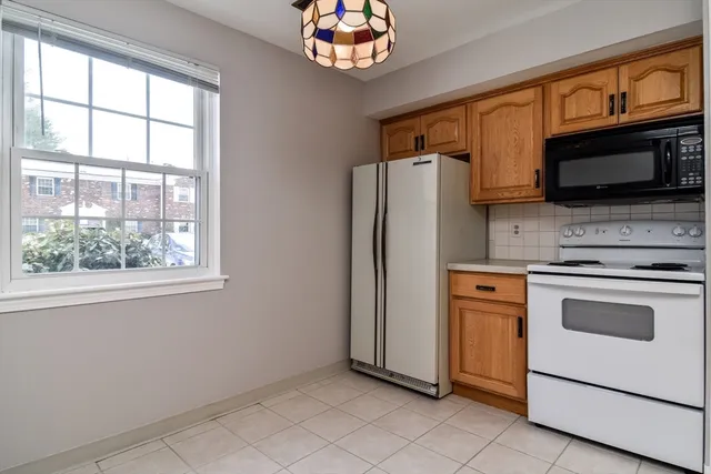 a kitchen with stainless steel appliances a stove microwave and a refrigerator