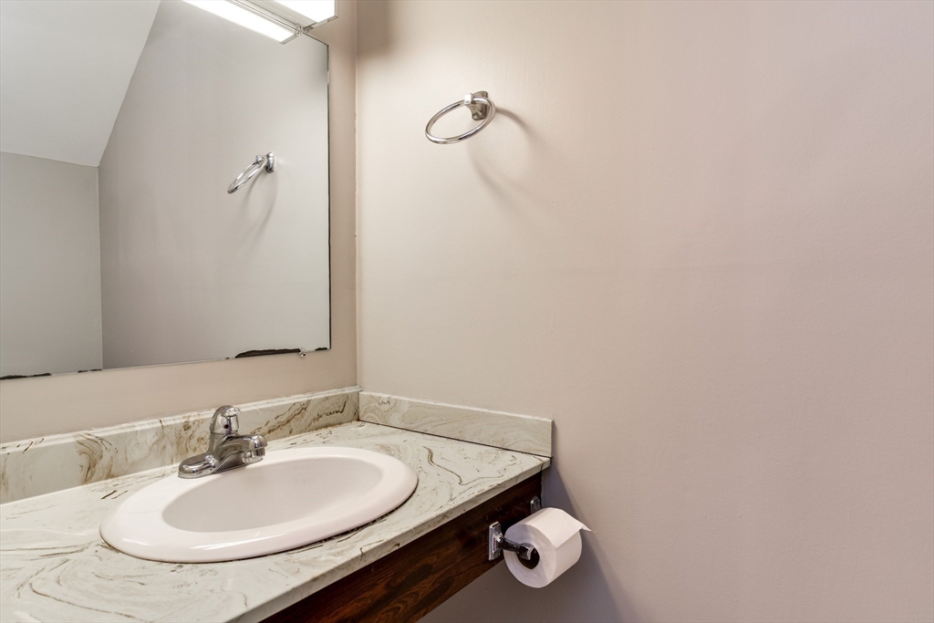 1907 Windsor Drive, Unit 1907 Framingham, MA 01701 - Photo 9 of 22 a bathroom with a sink and a mirror