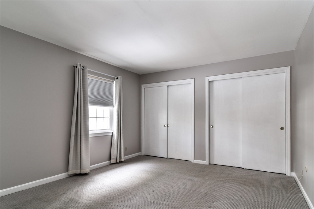 1907 Windsor Drive, Unit 1907 Framingham, MA 01701 - Photo 10 of 22 an empty room with windows and closet