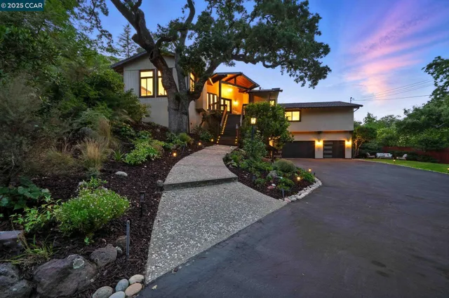 a front view of house with yard and green space