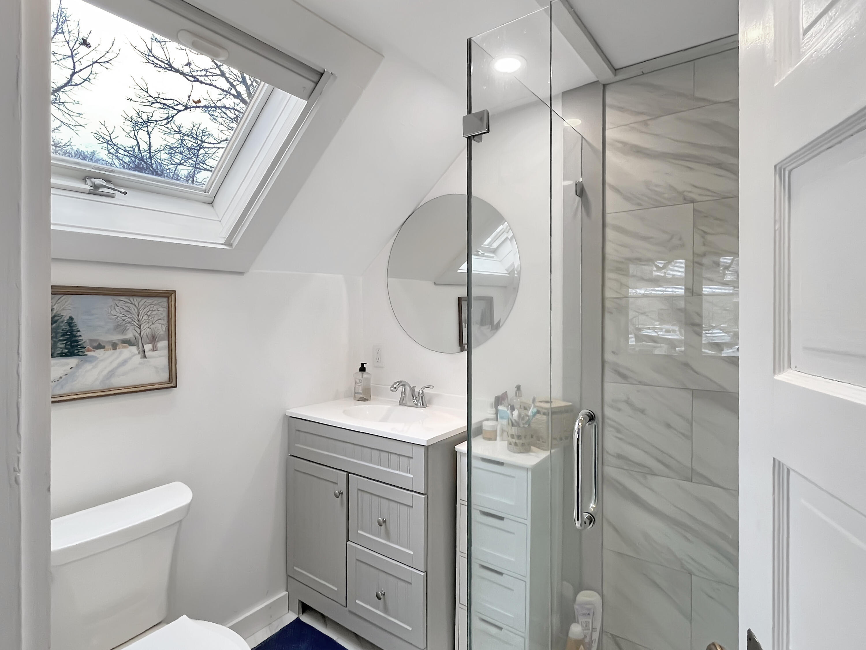 378 State Road Vineyard Haven, MA 02568 - Photo 17 of 23 a bathroom with a toilet a sink and glass door