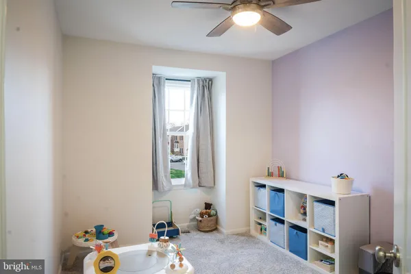 a bathroom with a toilet a sink a mirror a vanity and shower