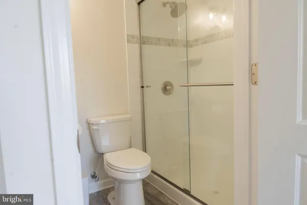 a bathroom with a toilet sink vanity and mirror