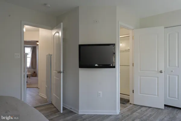 a bedroom with a bed and a computer on a desk