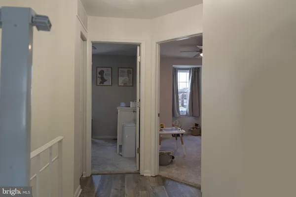 a view of a livingroom with furniture and a ceiling fan