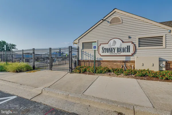 a view of a swimming pool with lawn chairs and a yard