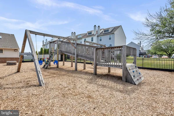 a view of a backyard with lawn chairs and a lake view