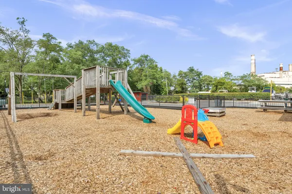 a view of a lake with a big yard and large trees