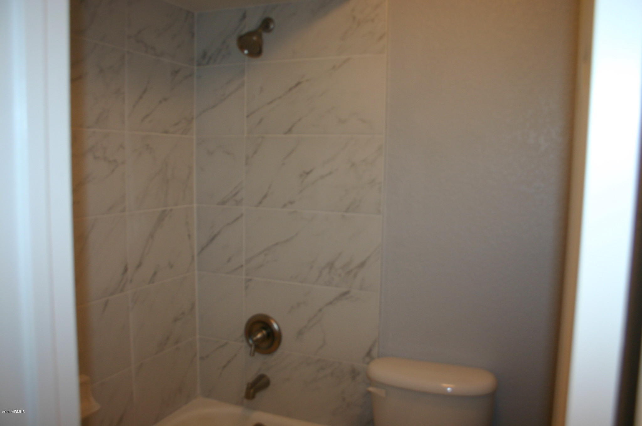 8787 East Mountain View Road, Unit 1014 Scottsdale, AZ 85258 - Photo 16 of 27 a bathroom with a toilet and a shower