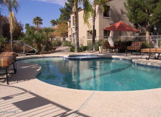 8787 East Mountain View Road, Unit 1014 Scottsdale, AZ 85258 - Photo 23 of 27 a swimming pool with outdoor seating and yard