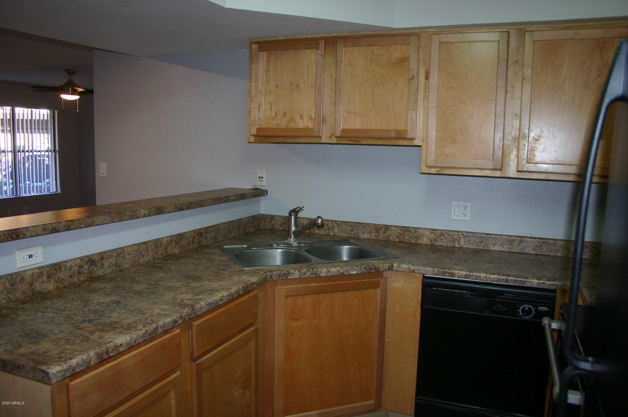8787 East Mountain View Road, Unit 1014 Scottsdale, AZ 85258 - Photo 3 of 27 a kitchen with granite countertop stainless steel appliances a sink stove and cabinets