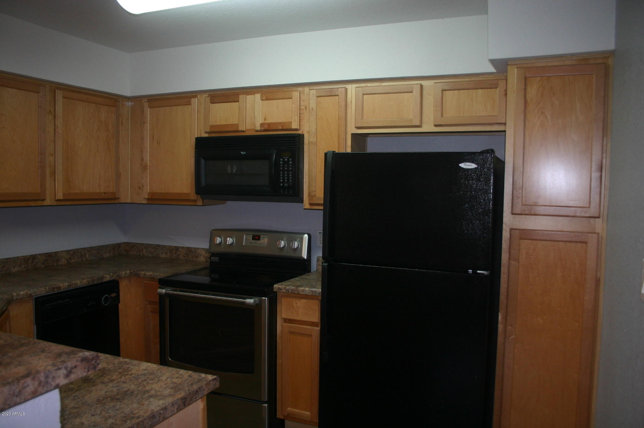 8787 East Mountain View Road, Unit 1014 Scottsdale, AZ 85258 - Photo 4 of 27 a kitchen with a refrigerator stove and microwave