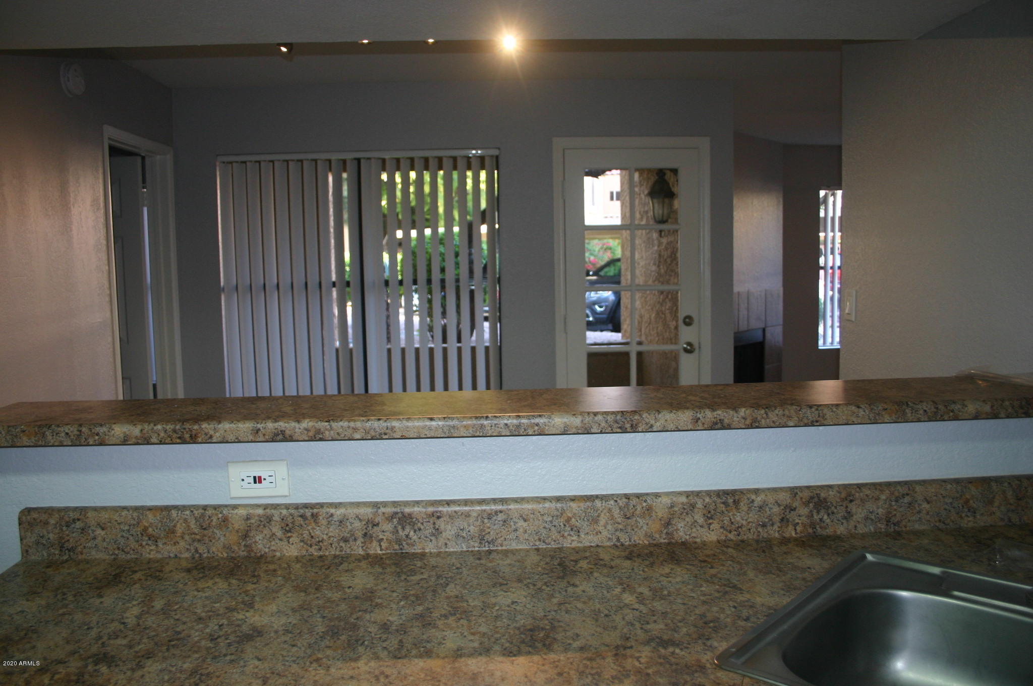 8787 East Mountain View Road, Unit 1014 Scottsdale, AZ 85258 - Photo 6 of 27 a living room with a sink and chandelier