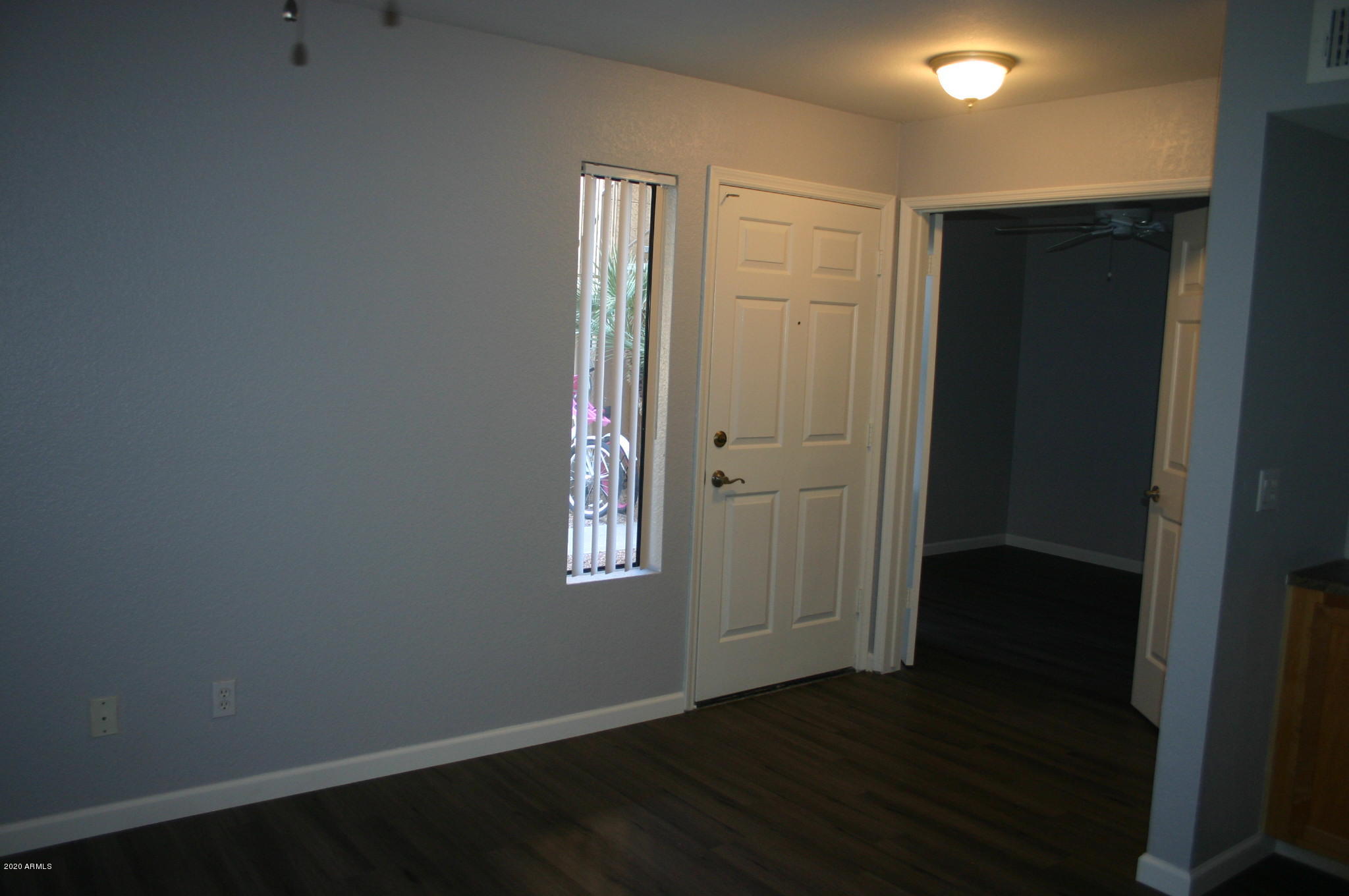 8787 East Mountain View Road, Unit 1014 Scottsdale, AZ 85258 - Photo 7 of 27 an empty room with wooden floor closet and windows