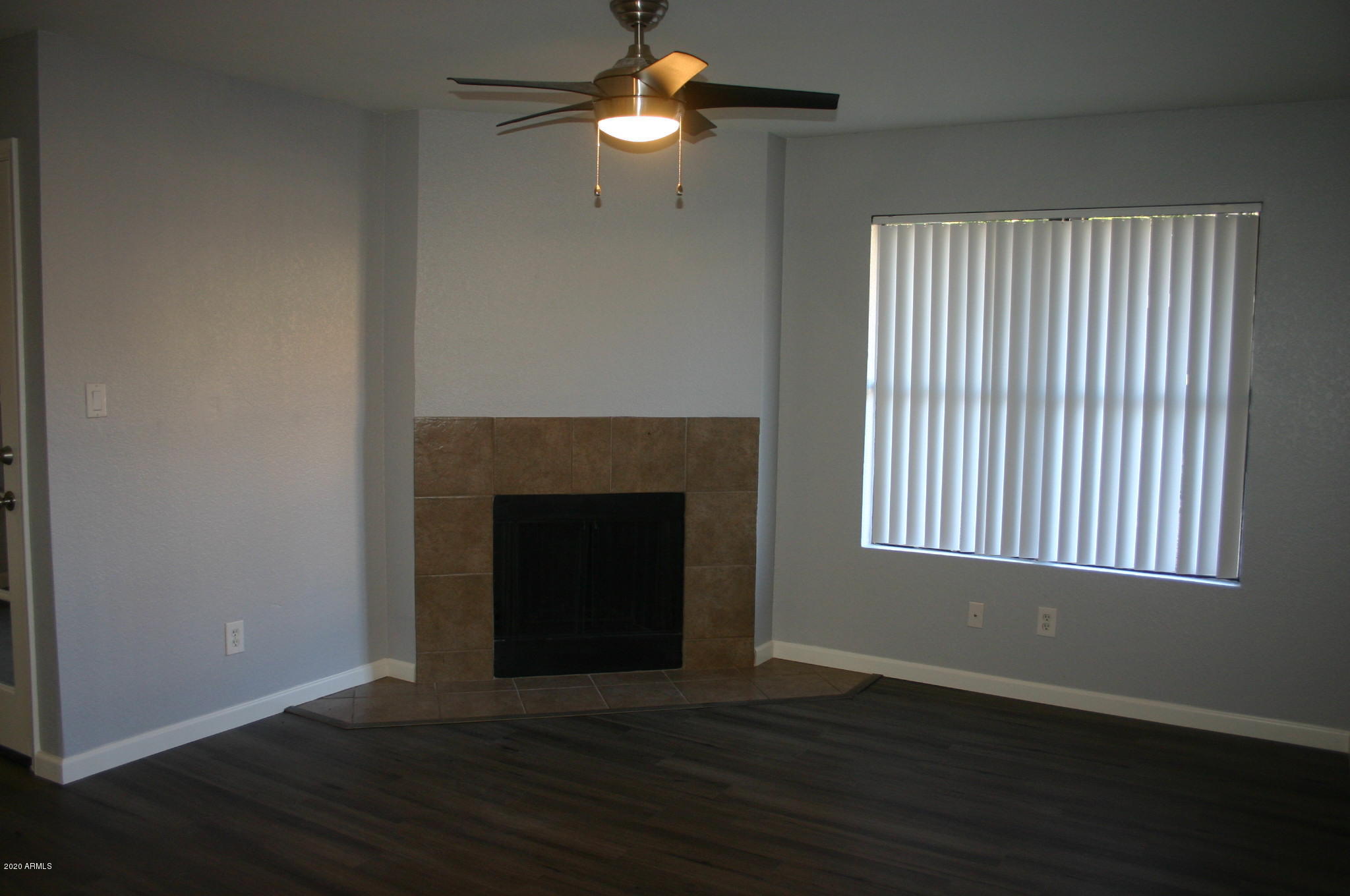 8787 East Mountain View Road, Unit 1014 Scottsdale, AZ 85258 - Photo 9 of 27 a view of a livingroom with a fireplace wooden floor and fan