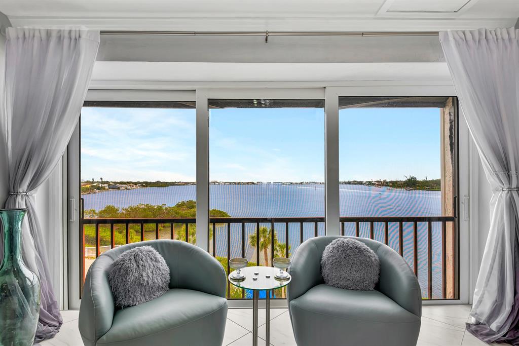 1602 Stickney Point Road, Unit 404 Sarasota, FL 34231 - Photo 17 of 38 a balcony with furniture and a large window