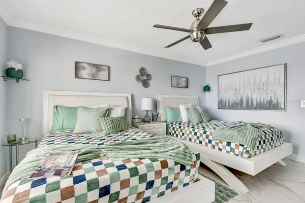 a bedroom with a bed and a chandelier