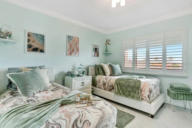 a bedroom with two beds and a couch