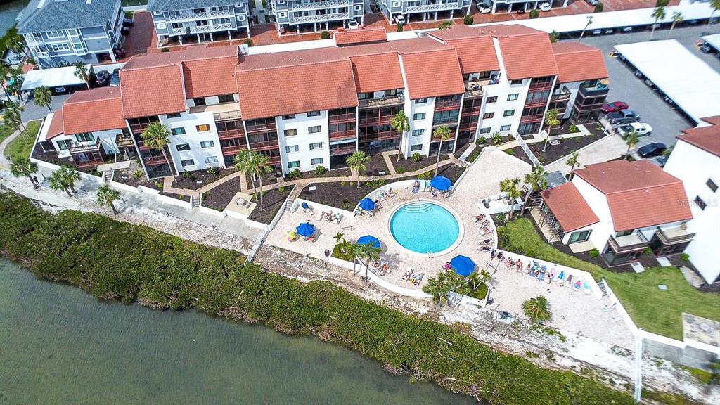 1602 Stickney Point Road, Unit 404 Sarasota, FL 34231 - Photo 29 of 38 an aerial view of a house roof deck and outdoor seating