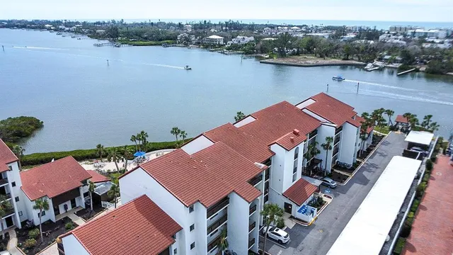 an aerial view of a house with outdoor space and lake view