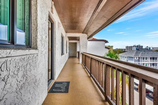 a view of a balcony with wooden floor and stairs