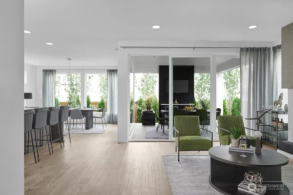 a living room with furniture a rug a fireplace and a large window