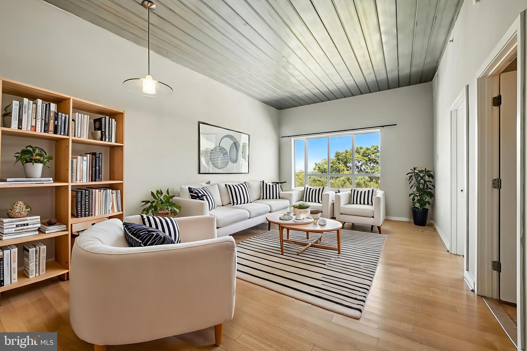 a living room with furniture and a book shelf