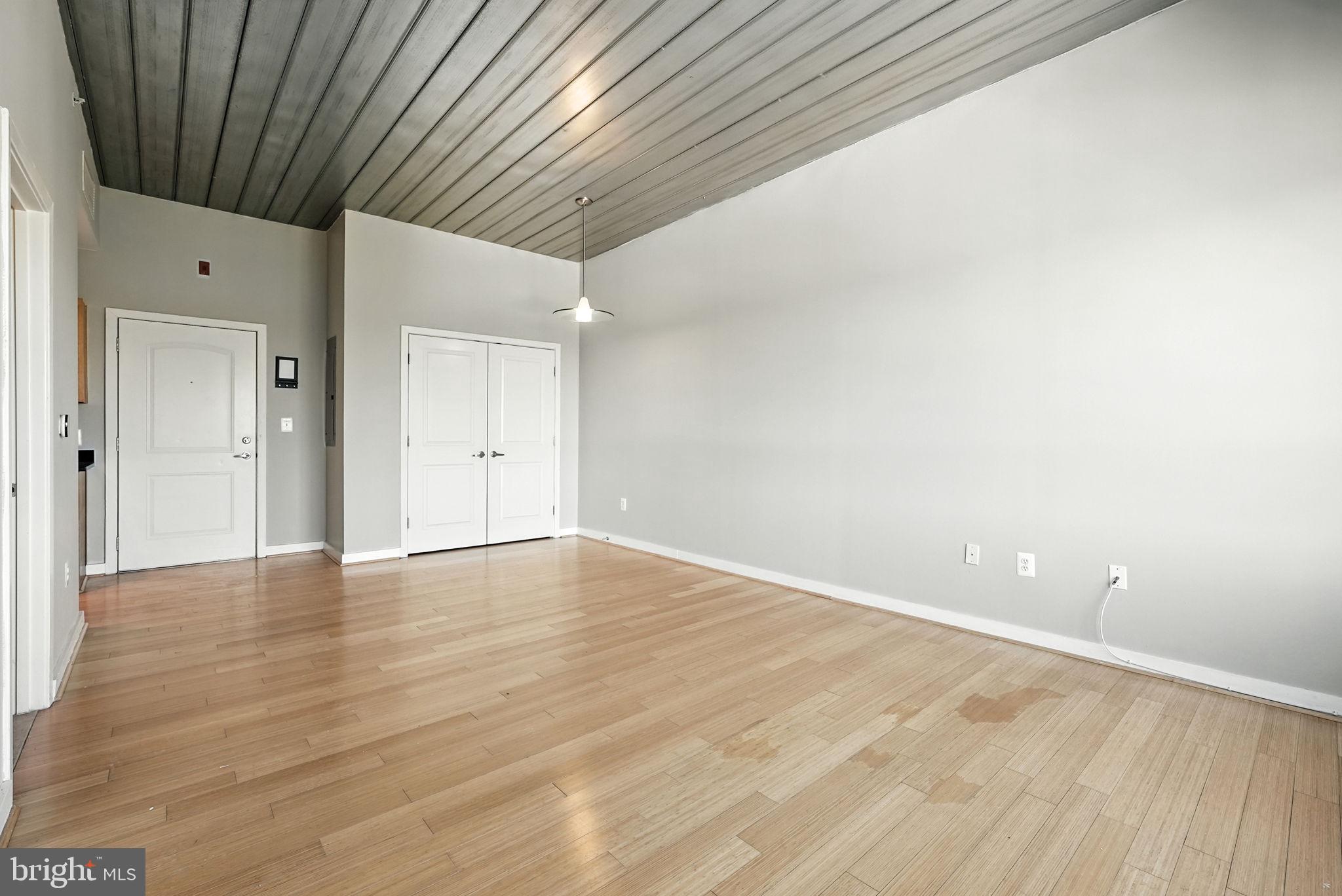 5885 Colorado Avenue Northwest, Unit 402 Washington, DC 20011 - Photo 4 of 30 a view of an empty room with wooden floor and a window