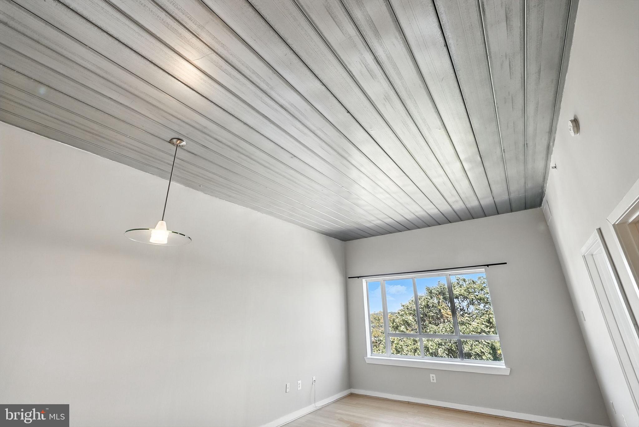 5885 Colorado Avenue Northwest, Unit 402 Washington, DC 20011 - Photo 6 of 30 a view of a room with a large window and wooden floor