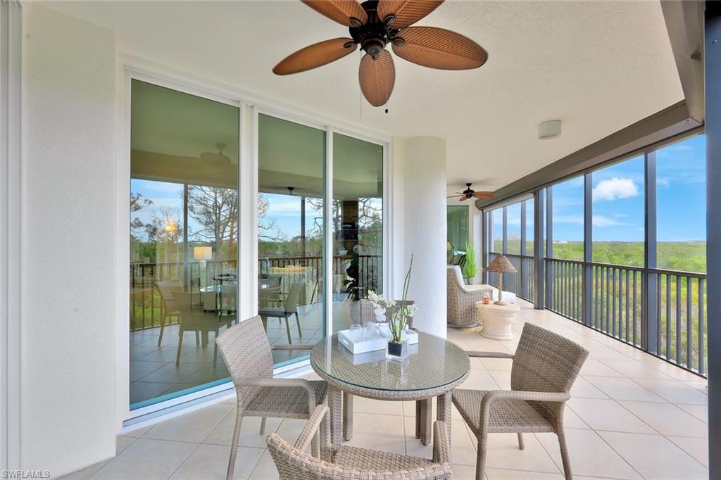 445 Cove Tower Drive, Unit 403 Naples, FL 34110 - Photo 19 of 42 a view of a dining room with furniture window and outside view