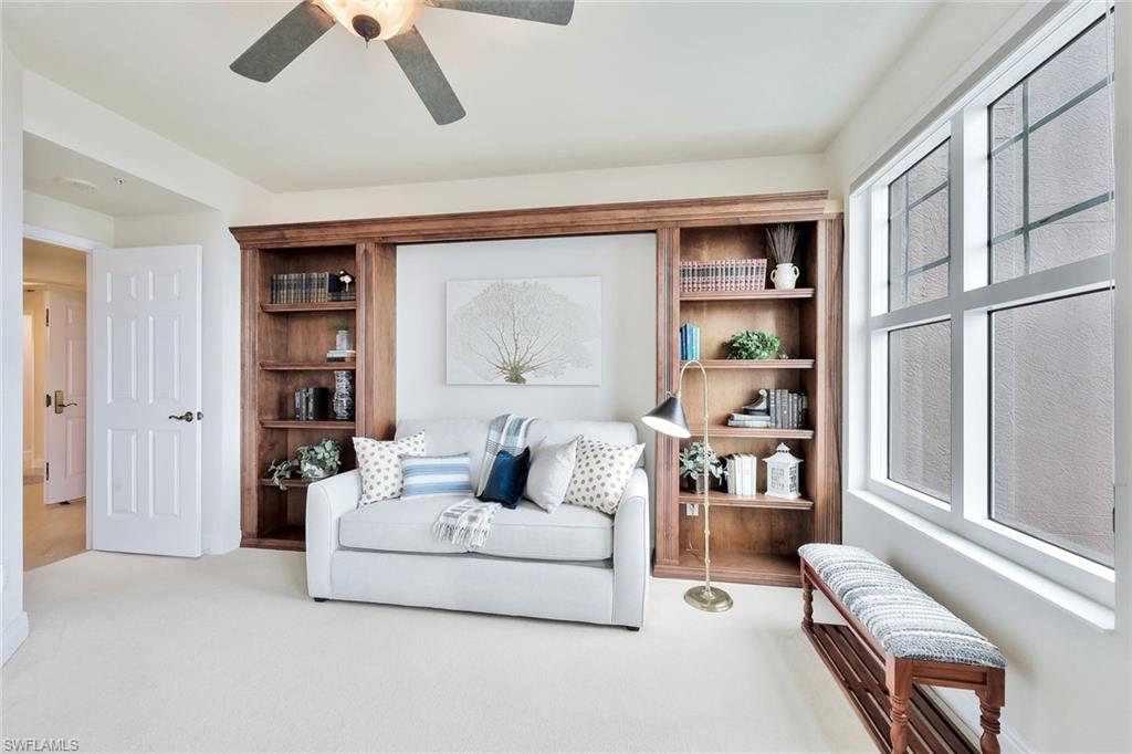 445 Cove Tower Drive, Unit 403 Naples, FL 34110 - Photo 20 of 42 a living room with furniture and a window