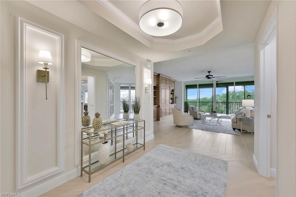 445 Cove Tower Drive, Unit 403 Naples, FL 34110 - Photo 2 of 42 a view of a livingroom with furniture and windows
