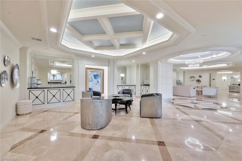445 Cove Tower Drive, Unit 403 Naples, FL 34110 - Photo 28 of 42 a living room with furniture and wooden floor
