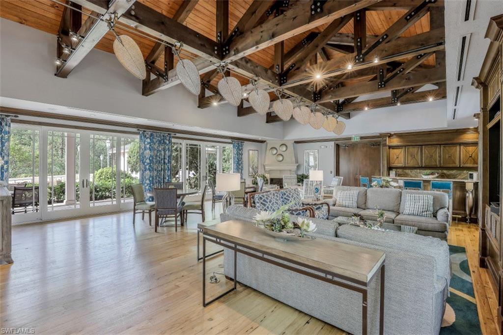 445 Cove Tower Drive, Unit 403 Naples, FL 34110 - Photo 39 of 42 a view of a dining room with furniture window and wooden floor