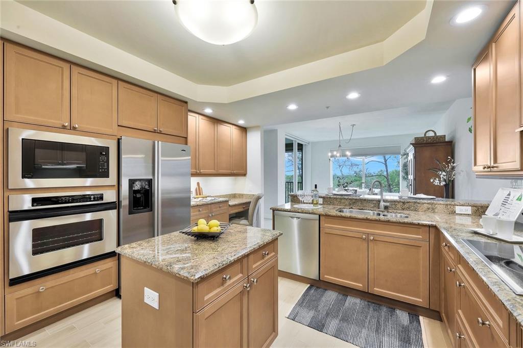 445 Cove Tower Drive, Unit 403 Naples, FL 34110 - Photo 6 of 42 a kitchen with a sink stove and refrigerator