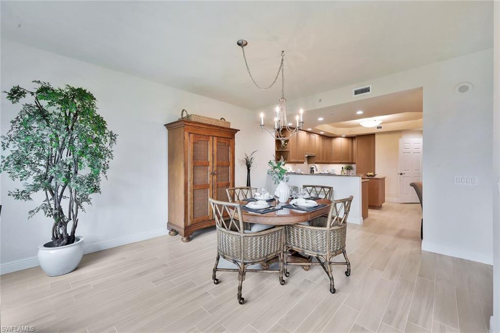 445 Cove Tower Drive, Unit 403 Naples, FL 34110 - Photo 10 of 42 a dining room with furniture and window