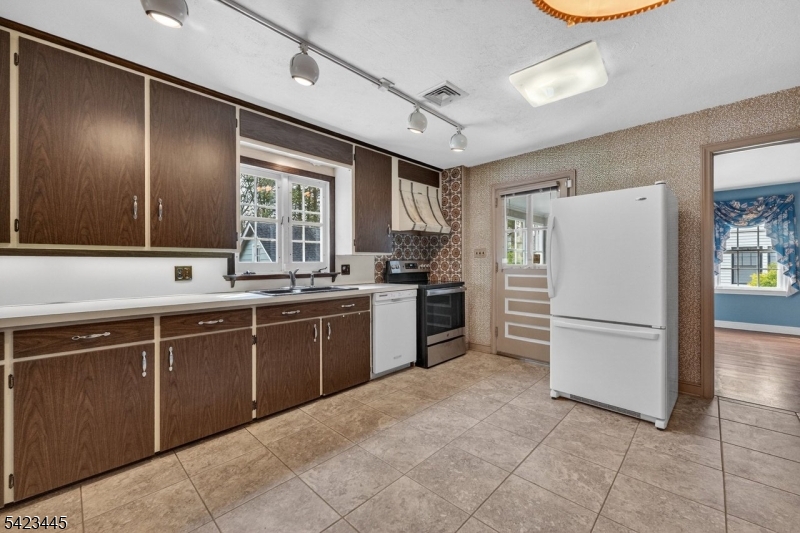 78 Orton Road West Caldwell, NJ 07006 - Photo 12 of 50 a kitchen with granite countertop stainless steel appliances a refrigerator sink and microwave