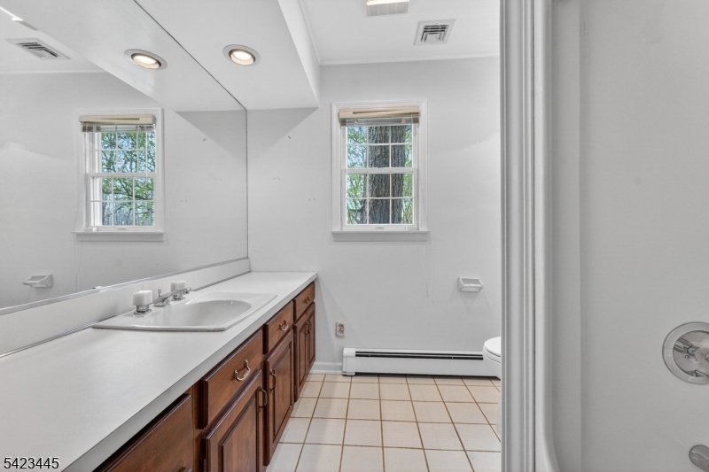 78 Orton Road West Caldwell, NJ 07006 - Photo 27 of 50 a bathroom with a sink a vanity and a shower