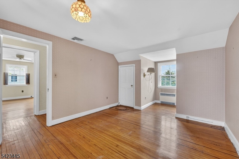 78 Orton Road West Caldwell, NJ 07006 - Photo 35 of 50 a view of an empty room with wooden floor and a window