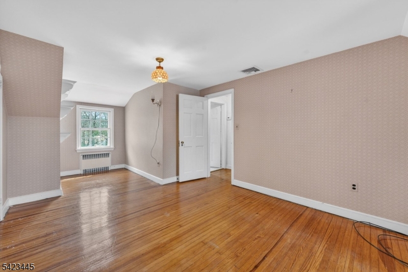 78 Orton Road West Caldwell, NJ 07006 - Photo 37 of 50 a view of an empty room with wooden floor and a window