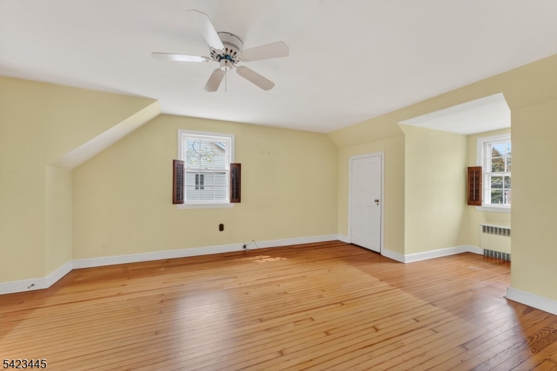 78 Orton Road West Caldwell, NJ 07006 - Photo 38 of 50 a view of an empty room with wooden floor and a ceiling fan