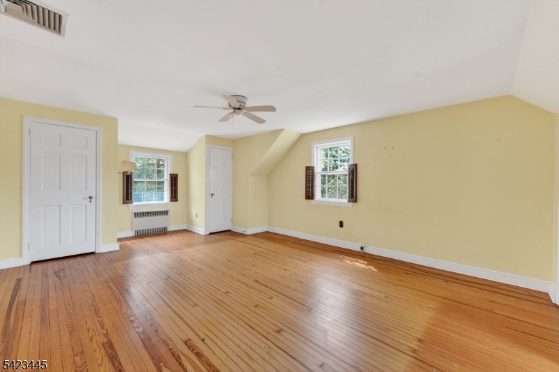 78 Orton Road West Caldwell, NJ 07006 - Photo 42 of 50 a view of an empty room with wooden floor and a window
