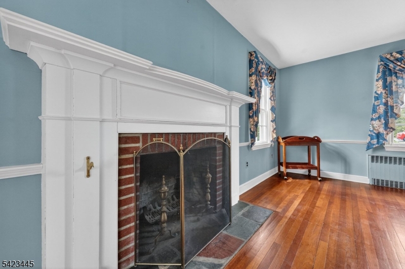78 Orton Road West Caldwell, NJ 07006 - Photo 5 of 50 a view of a livingroom with wooden floor and a fireplace