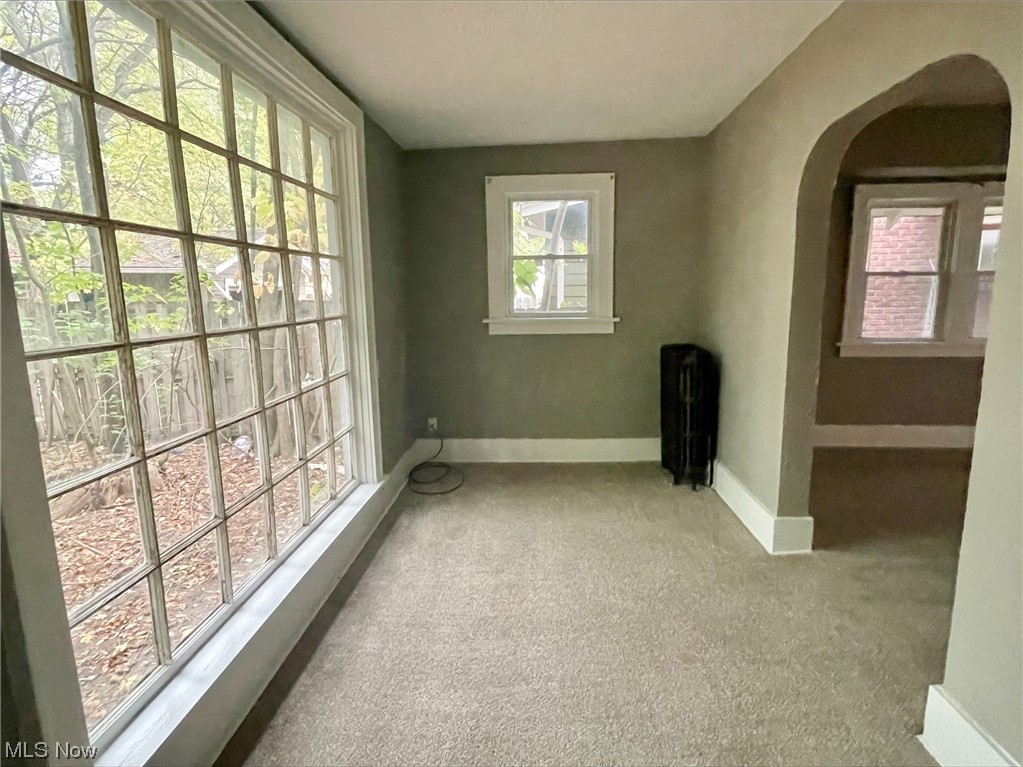 857 Aberdeen Street Akron, OH 44310 - Photo 5 of 23 Spare room with light colored carpet and radiator heating unit